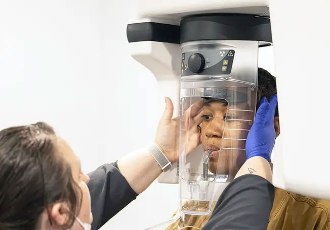 dental implant 3d cbct scan on screen dr adatrow explaining jaw anatomy treatment planning