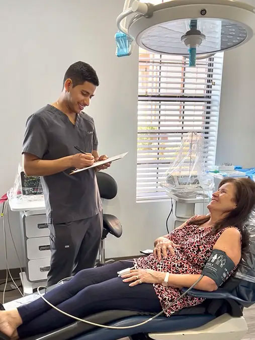 dental implant pre op consultation patient reviewing instructions dr adatrow memphis